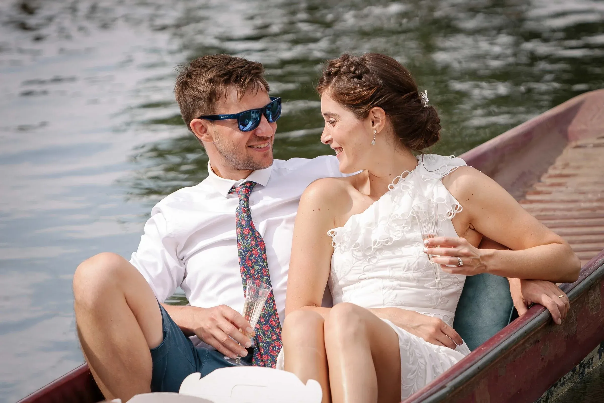 A newly married couple relaxing together in a small boat